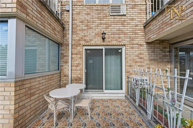 a front view of a house with a table and chairs