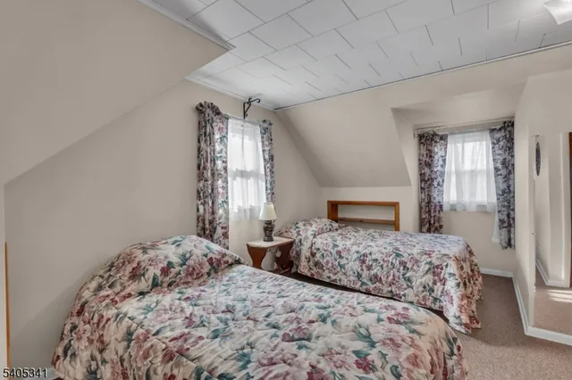 a bedroom with two beds and a fireplace