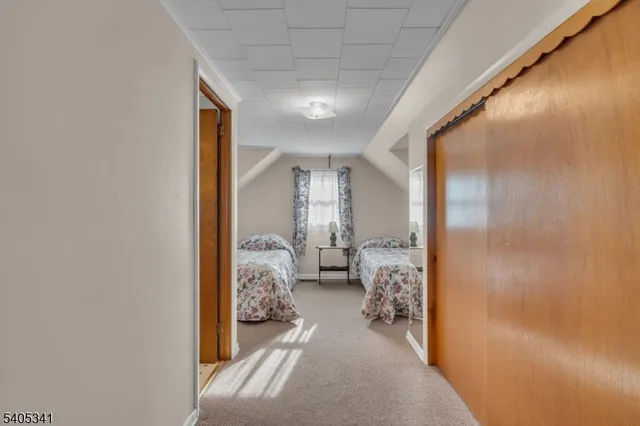 a view of a hallway to a livingroom and a couch