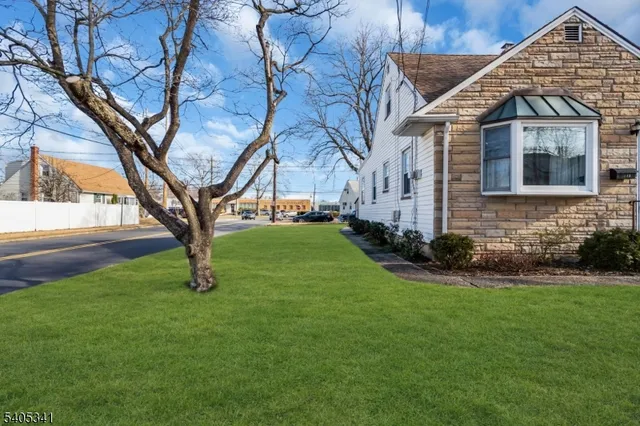 a view of a house with a yard covered in snow