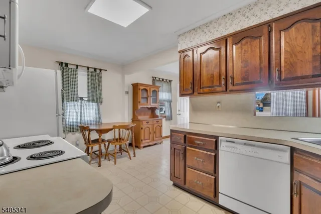 a kitchen with a stove a sink and a refrigerator