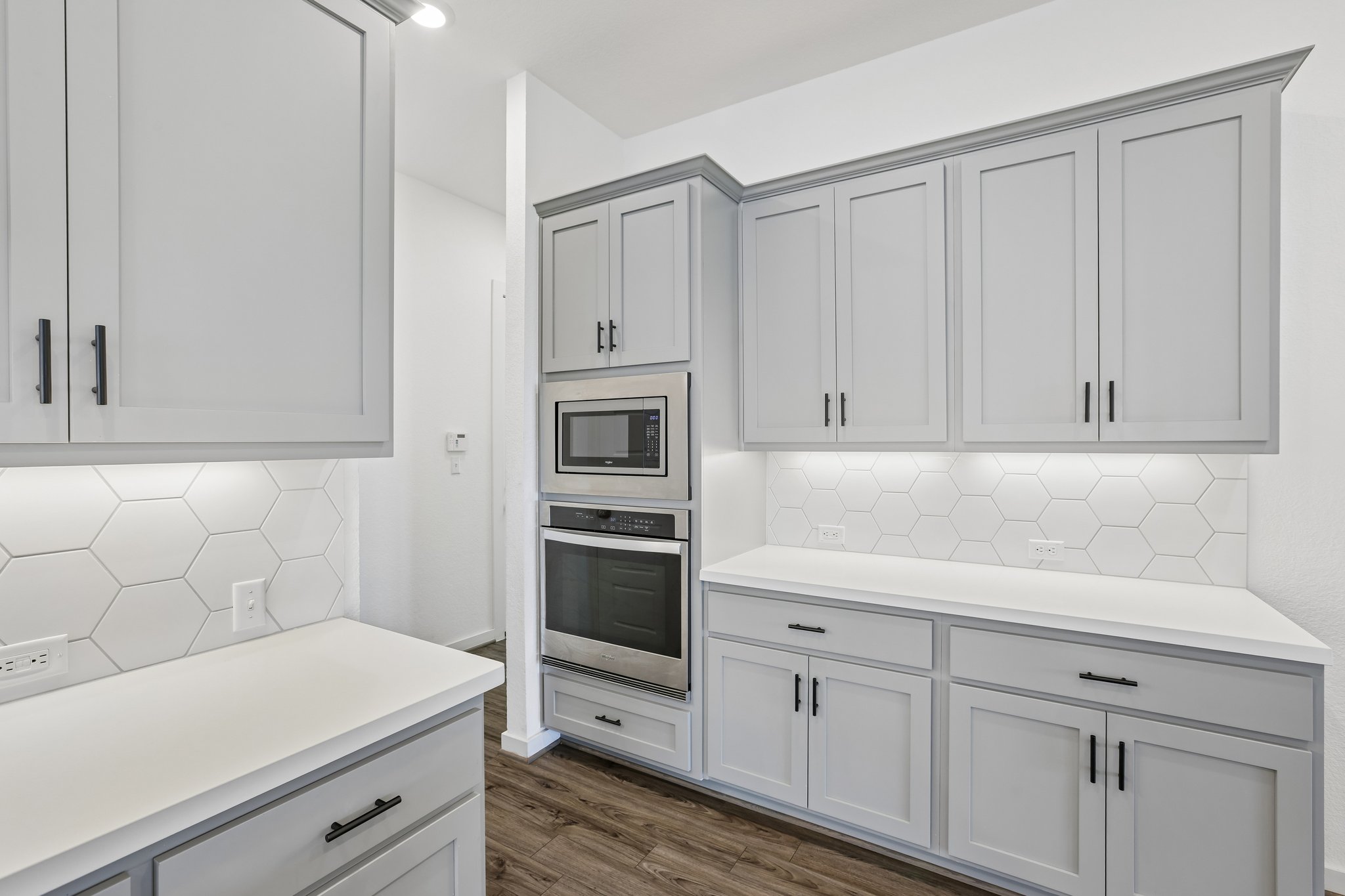 317 Independence Drive Kyle, TX 78640 - Photo 8 of 40 a kitchen with white cabinets and white appliances