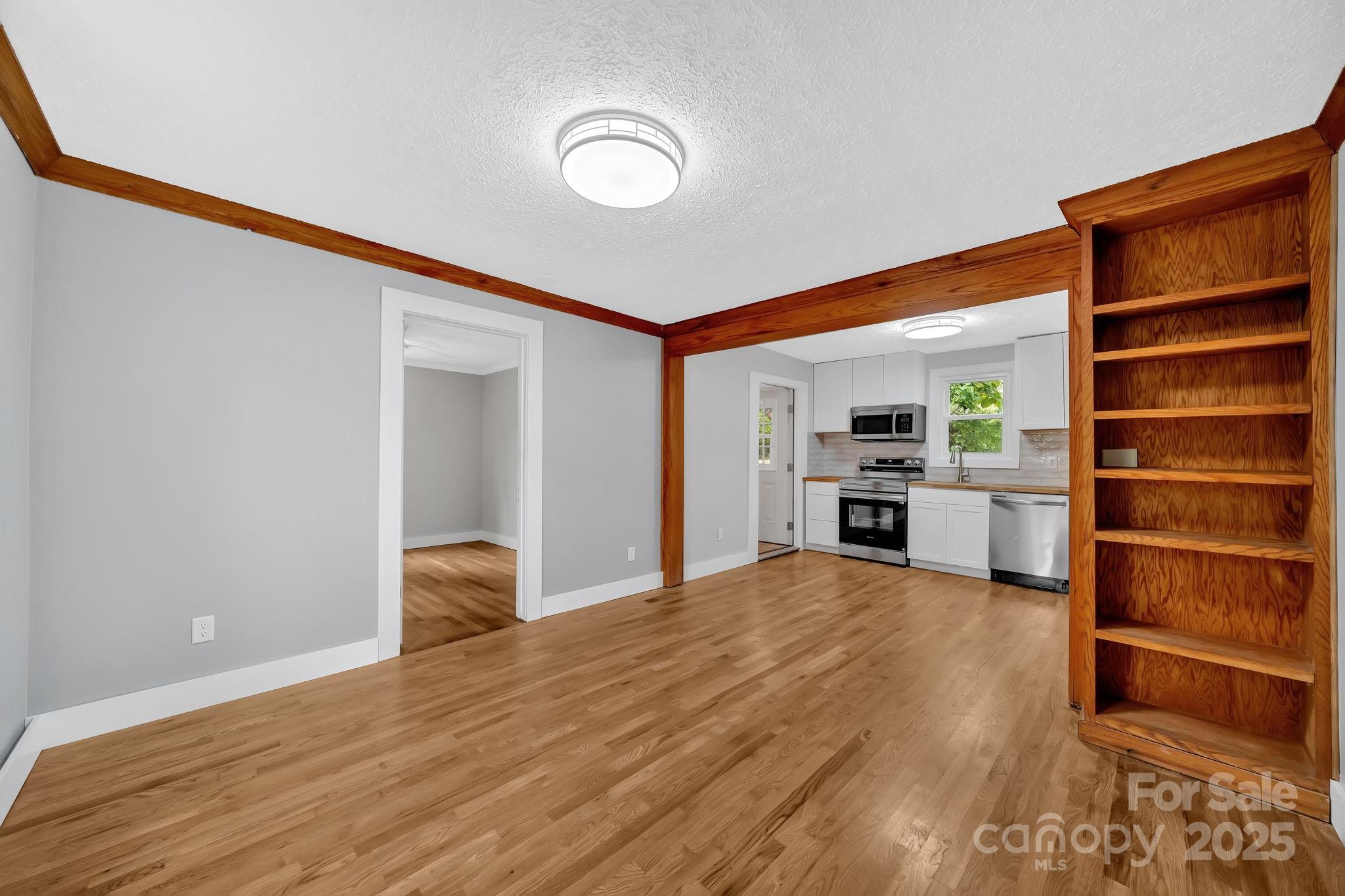 95 Whitmire Street Brevard, NC 28712 - Photo 13 of 34 a view of a kitchen with a fridge and a sink