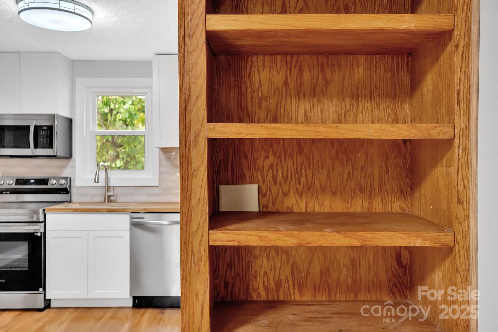 95 Whitmire Street Brevard, NC 28712 - Photo 15 of 34 a kitchen with a white cabinets and sink