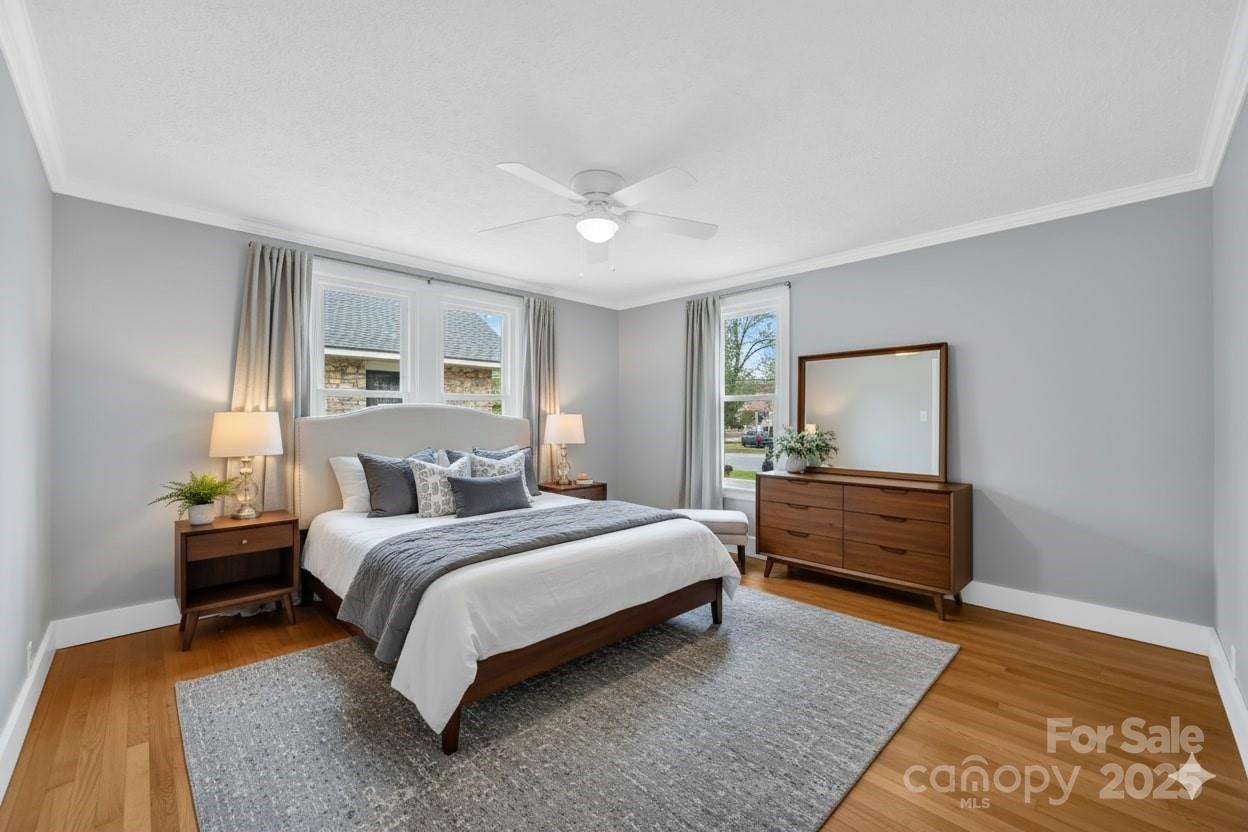 95 Whitmire Street Brevard, NC 28712 - Photo 20 of 34 a bedroom with a bed and wooden floor