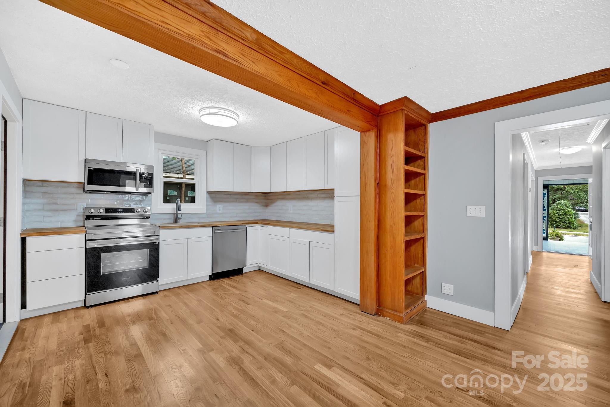 95 Whitmire Street Brevard, NC 28712 - Photo 21 of 34 a kitchen with stainless steel appliances a refrigerator and microwave
