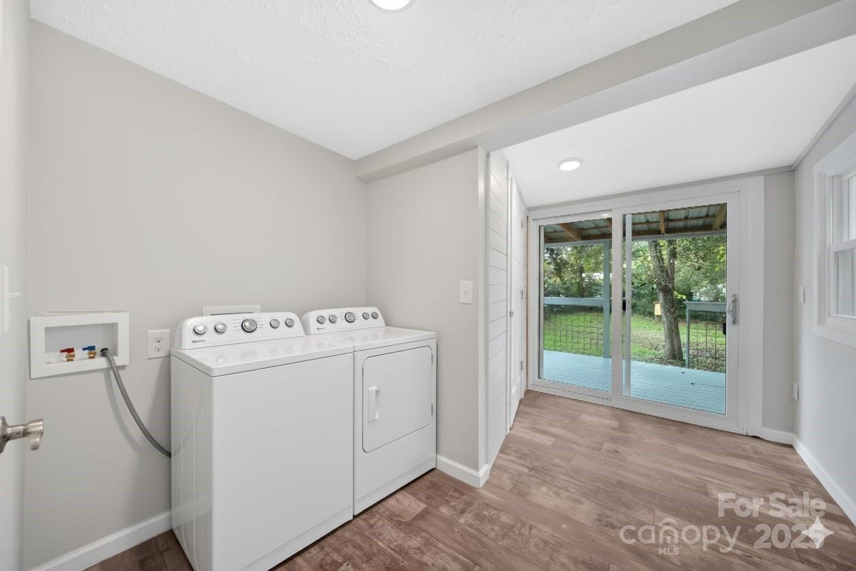 95 Whitmire Street Brevard, NC 28712 - Photo 24 of 34 a view of washer and dryer with kitchen in the background