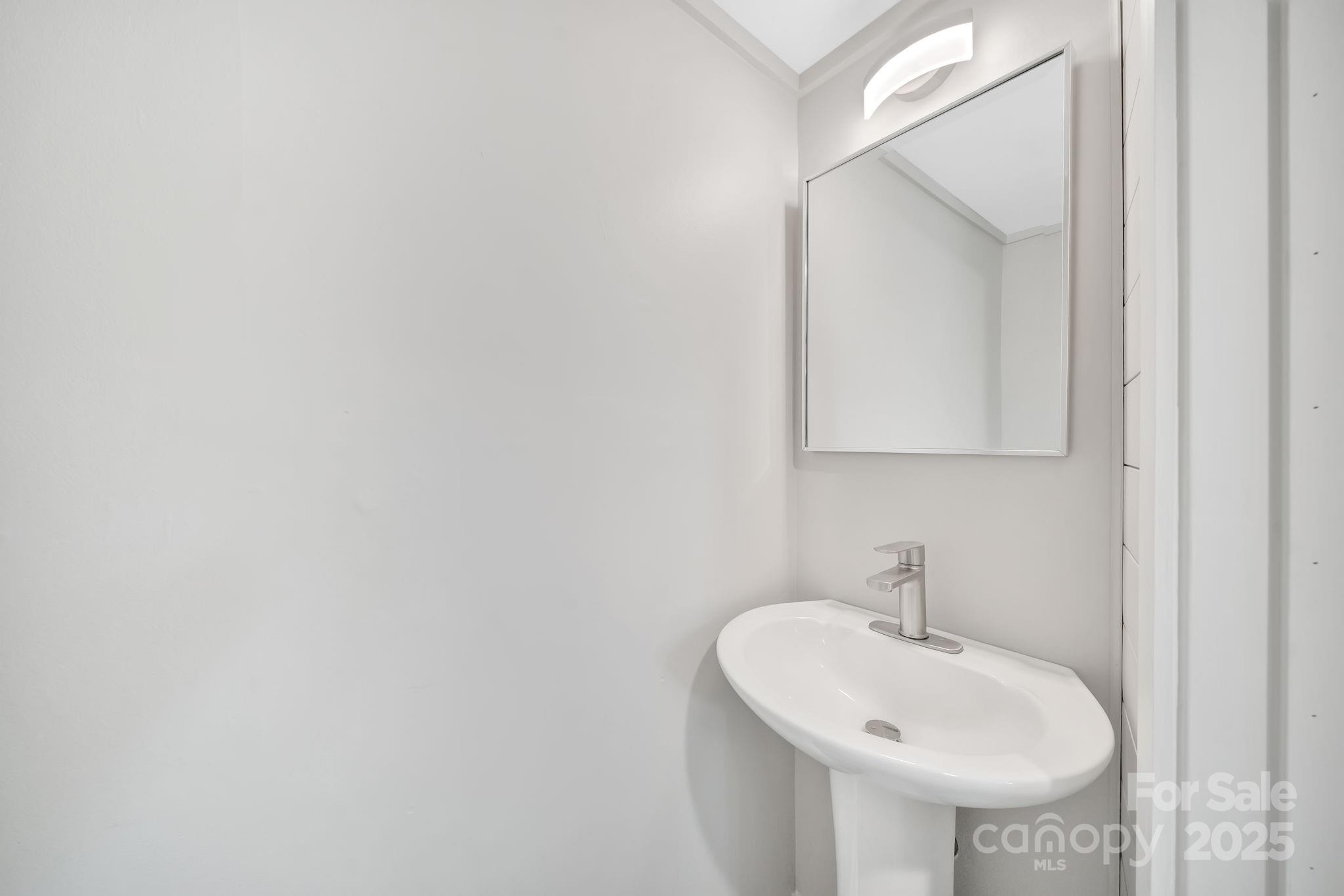 95 Whitmire Street Brevard, NC 28712 - Photo 26 of 34 a bathroom with a sink and a mirror