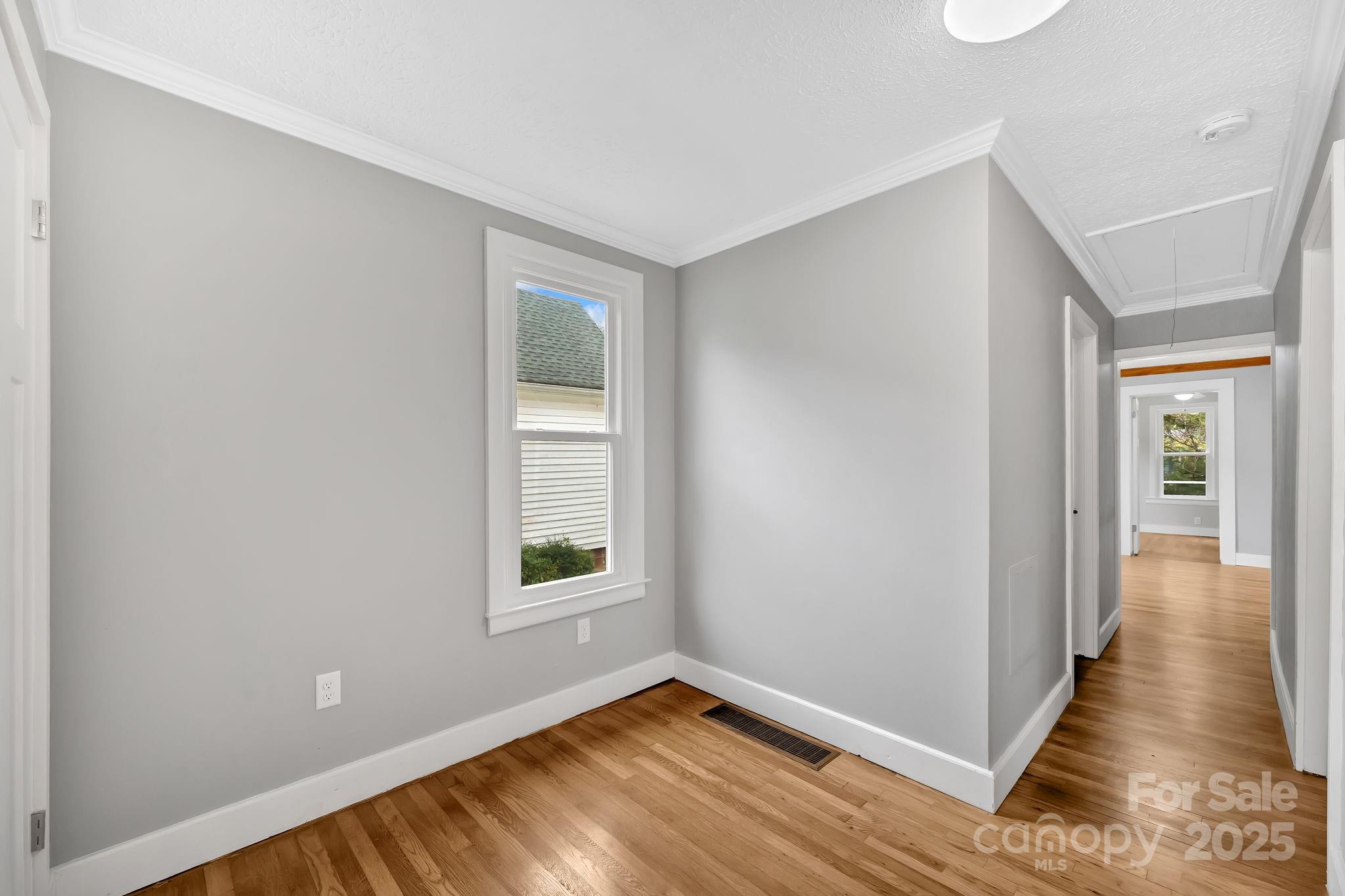 95 Whitmire Street Brevard, NC 28712 - Photo 7 of 34 an empty room with wooden floor and windows