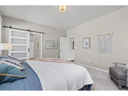 a bedroom with a bed and a couch