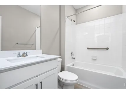 a bathroom with a sink toilet a mirror and shower