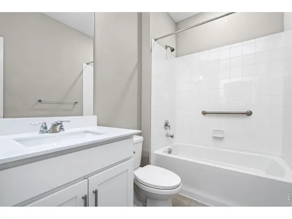 a bathroom with a sink toilet a mirror and shower