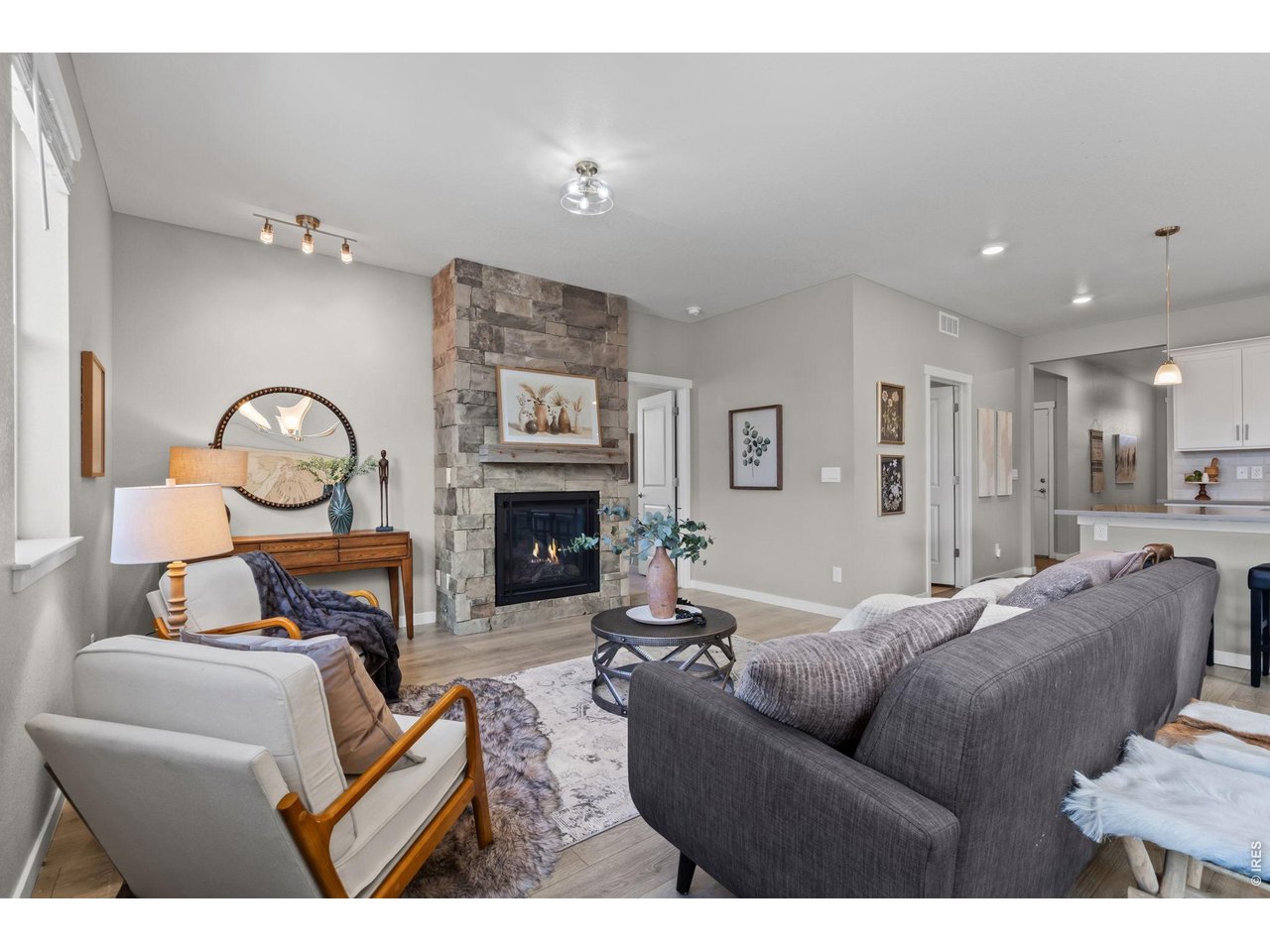 1577 Sun River Road Berthoud, CO 80513 - Photo 5 of 24 a living room with furniture a fireplace and a flat screen tv