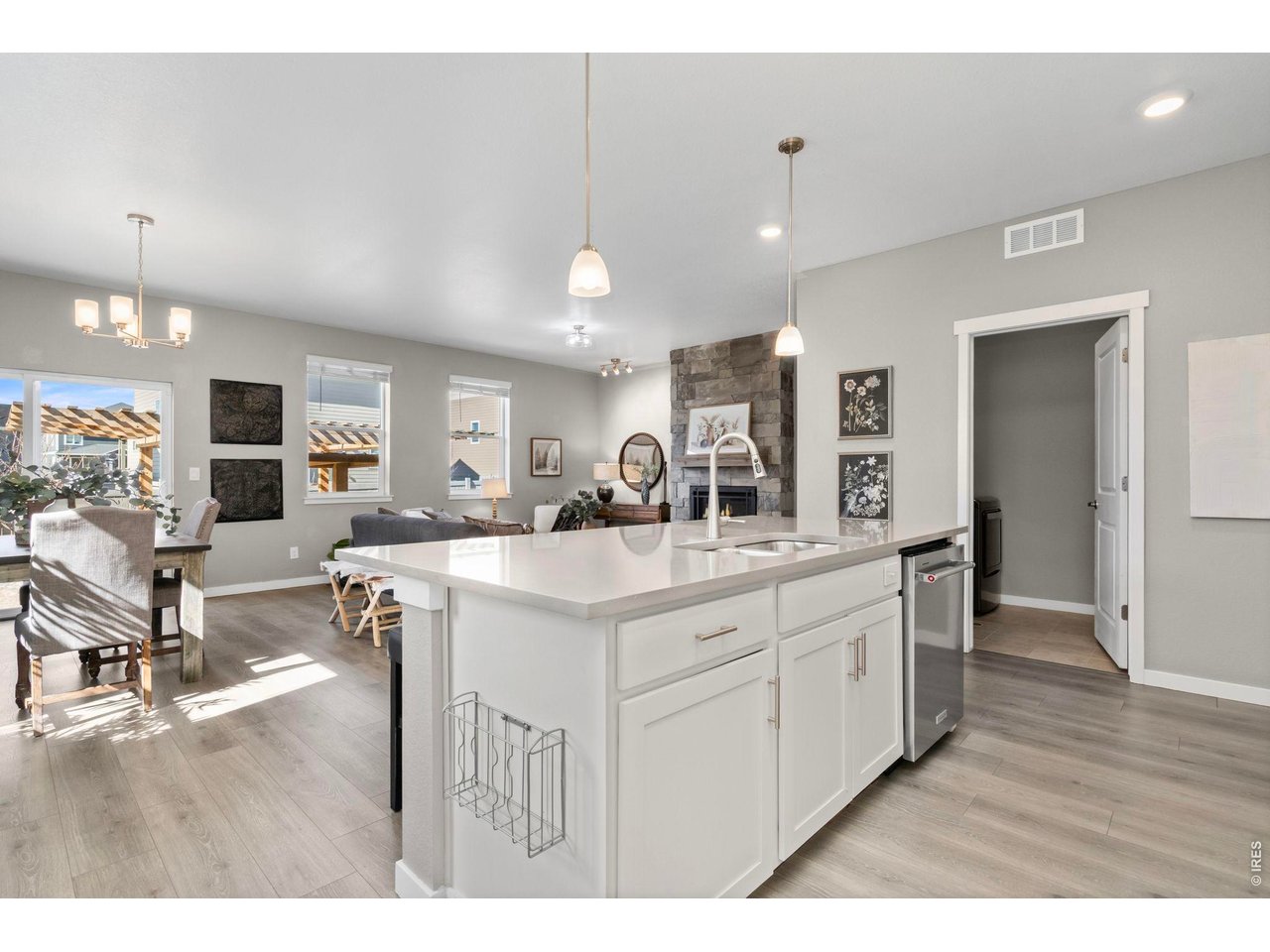 1577 Sun River Road Berthoud, CO 80513 - Photo 6 of 24 a kitchen with kitchen island granite countertop a sink cabinets and wooden floor