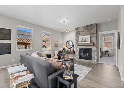 a living room with furniture a fireplace and a window