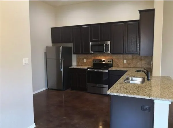 a kitchen with a refrigerator and a sink