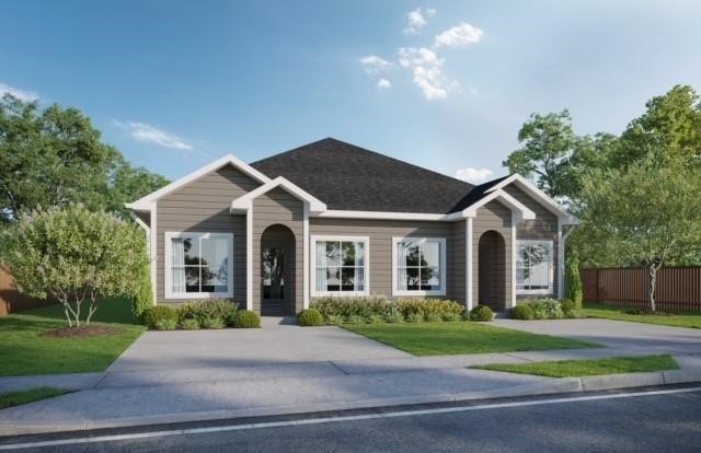 a front view of a house with a yard and a garage