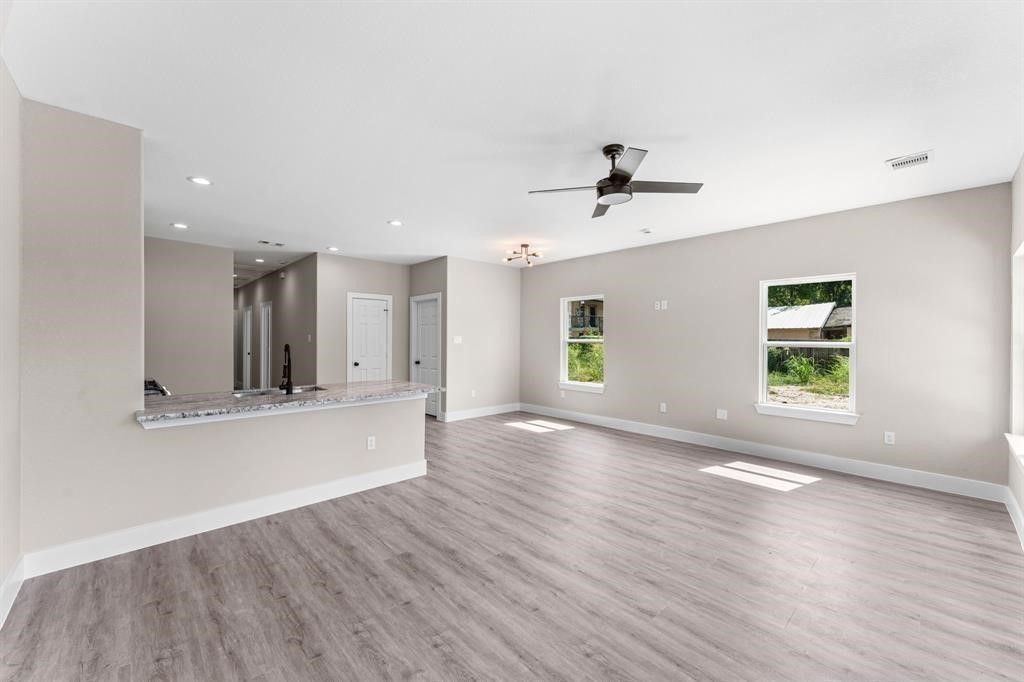 7311 Sandra Street, Unit B Houston, TX 77028 - Photo 2 of 8 a view of an empty room with window and wooden floor