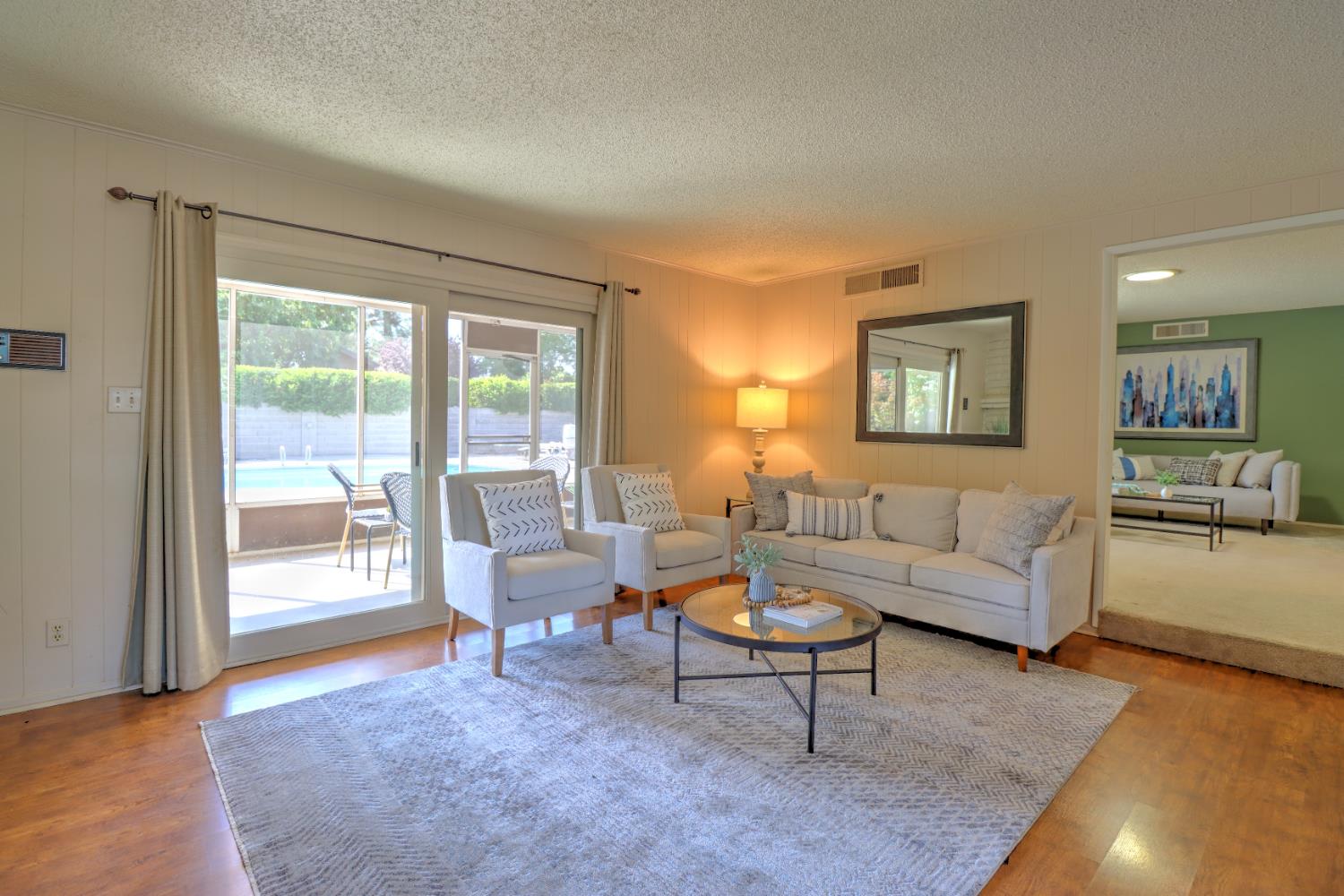 6265 North Colonial Avenue Fresno, CA 93704 - Photo 9 of 22 a living room with furniture and a large window