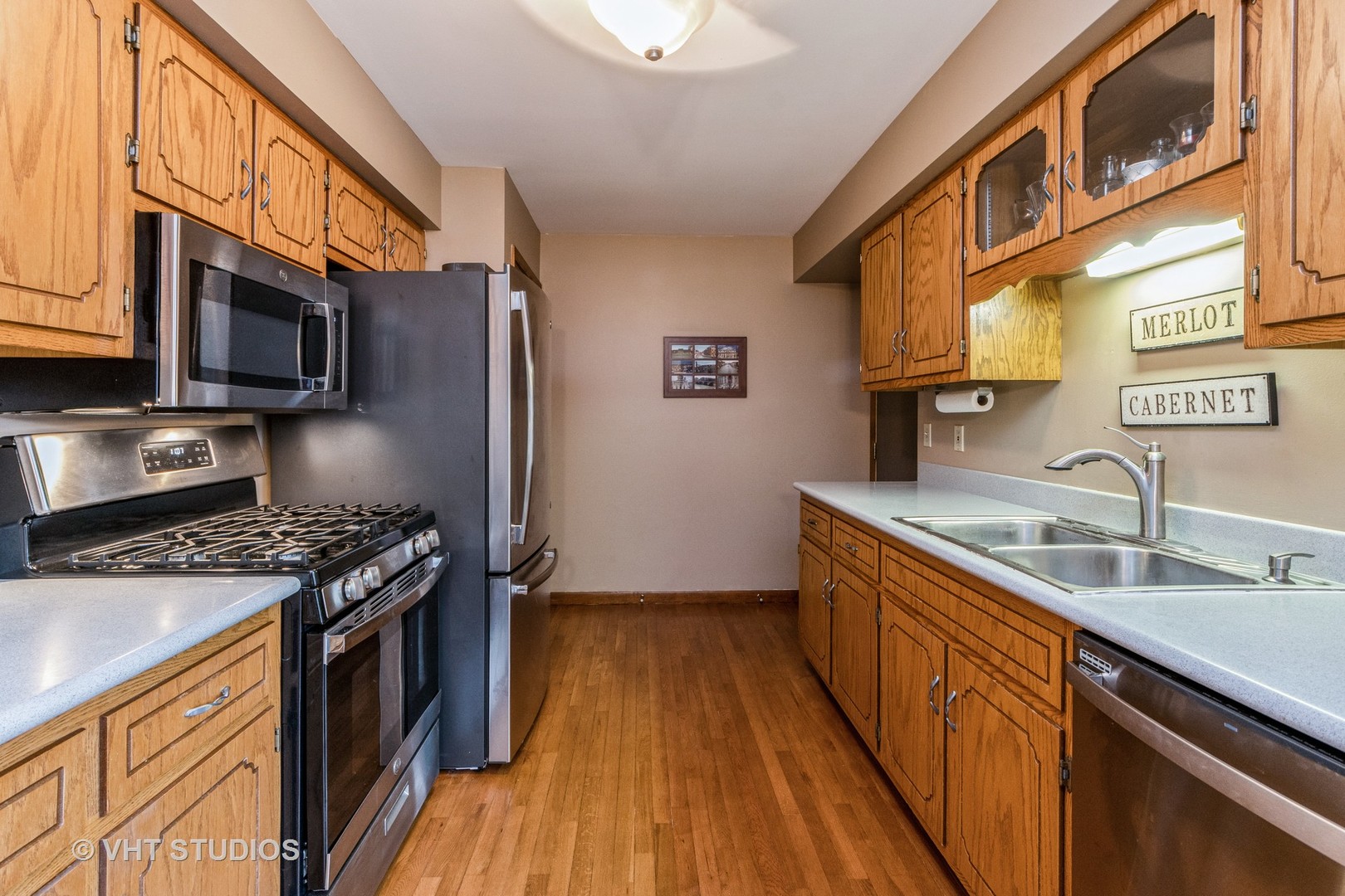 718 Sojourn Road New Lenox, IL 60451 - Photo 5 of 16 a kitchen with stainless steel appliances granite countertop a stove a sink and a microwave