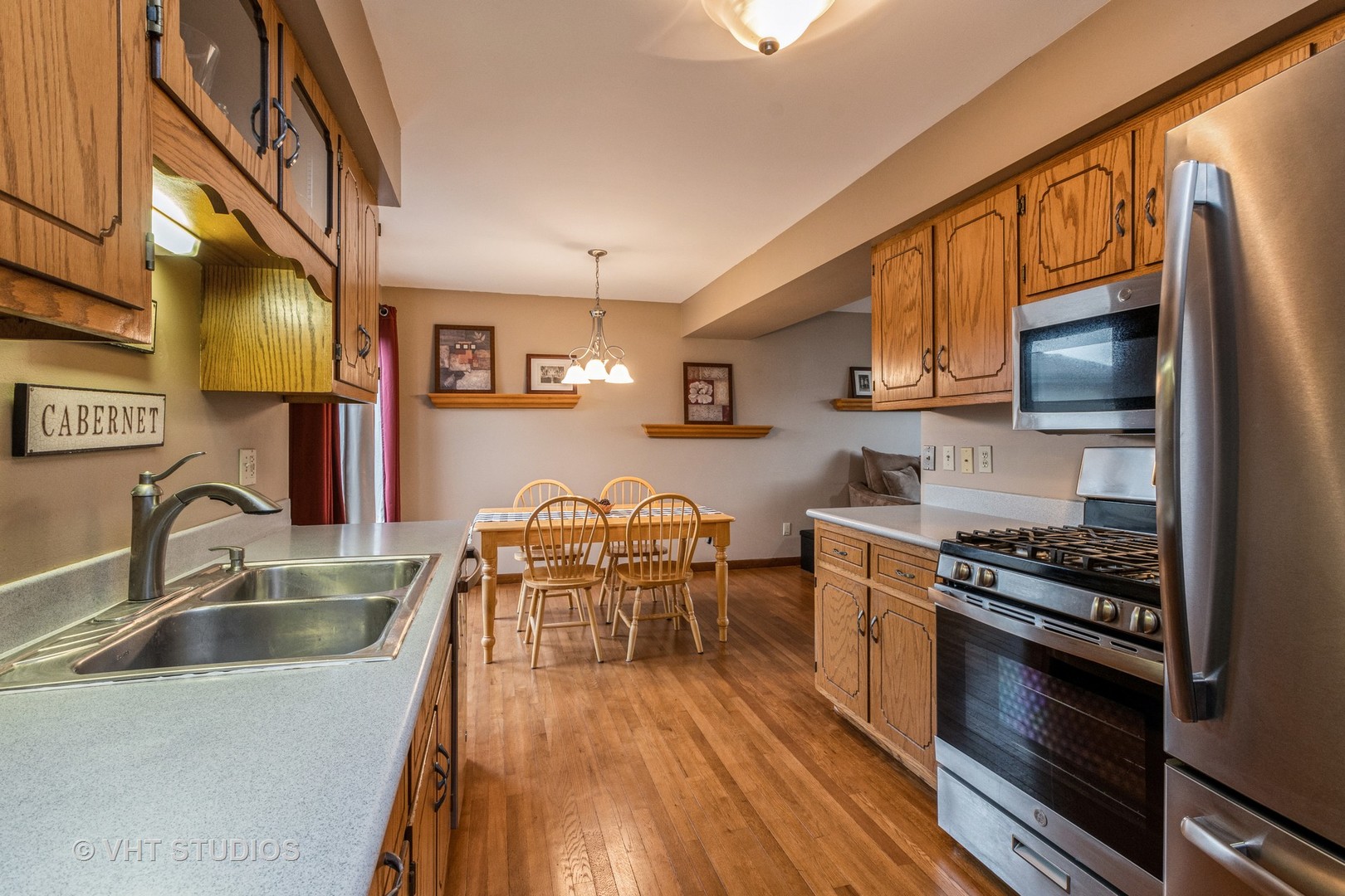 718 Sojourn Road New Lenox, IL 60451 - Photo 6 of 16 a kitchen with stainless steel appliances a stove sink microwave and cabinets