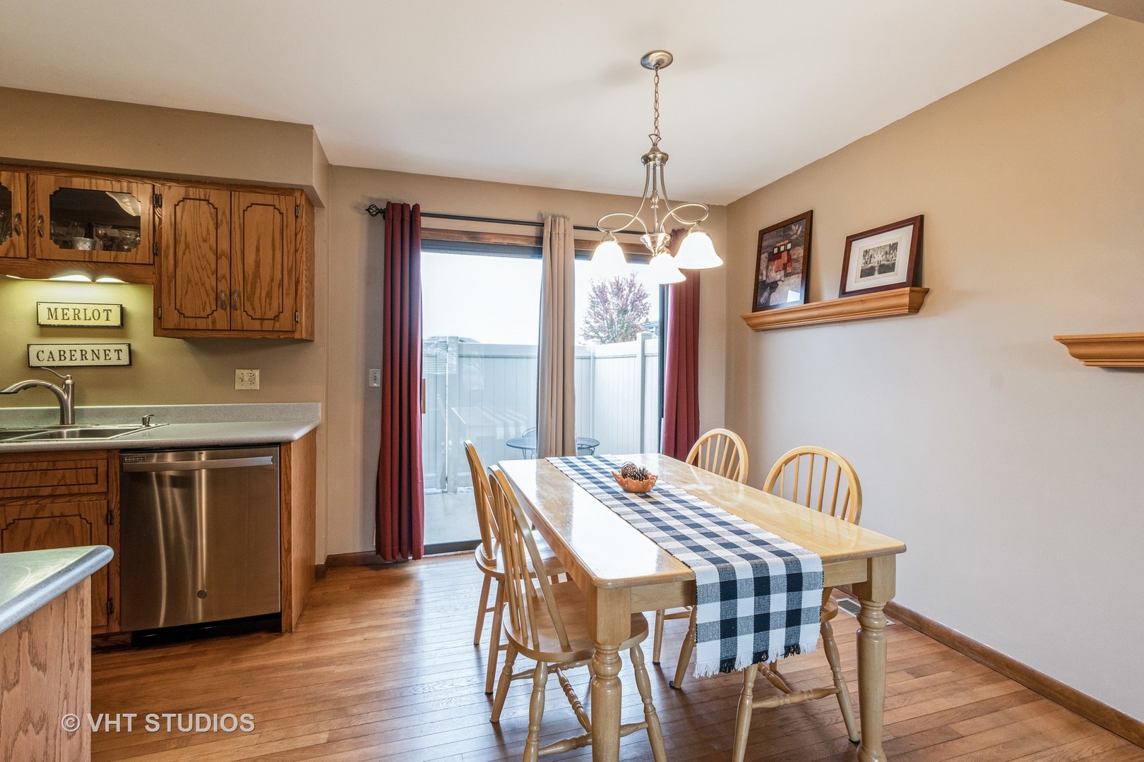 718 Sojourn Road New Lenox, IL 60451 - Photo 7 of 16 a view of a dining room with furniture wooden floor and chandelier
