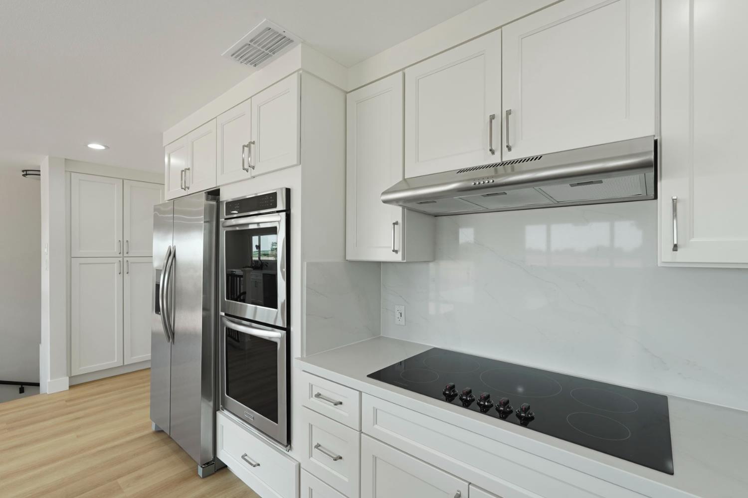 2650 West Twitchell Island Road Rio Vista, CA 94571 - Photo 31 of 60 a kitchen with granite countertop white cabinets and stainless steel appliances