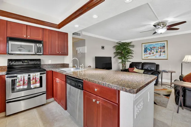 a kitchen with stainless steel appliances granite countertop a stove sink and cabinets