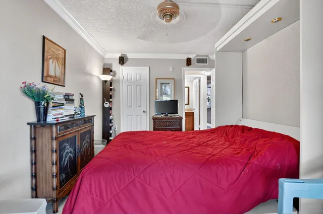 a bed room with a bed and a flat tv screen