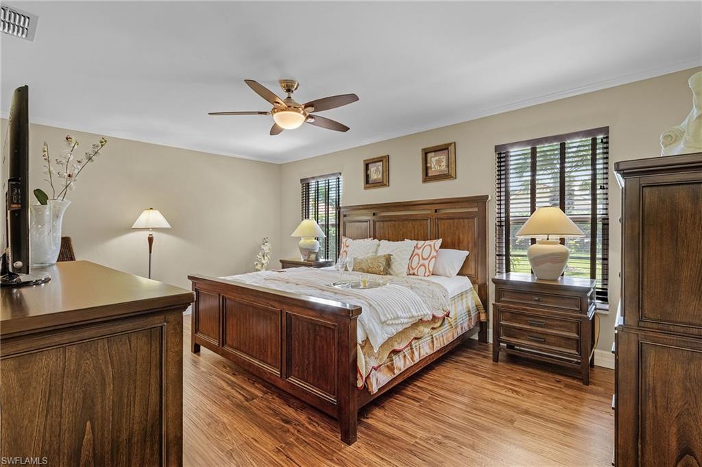 128 Plantation Circle Naples, FL 34104 - Photo 12 of 27 a bedroom with a bed and a flat tv screen on dresser