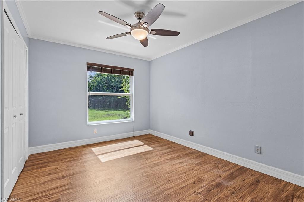 128 Plantation Circle Naples, FL 34104 - Photo 17 of 27 a view of empty room with wooden floor and fan
