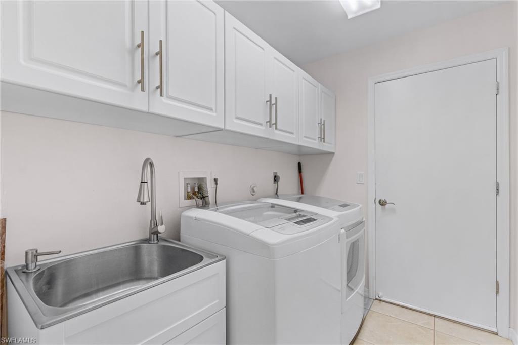 128 Plantation Circle Naples, FL 34104 - Photo 20 of 27 a utility room with dryer and washer