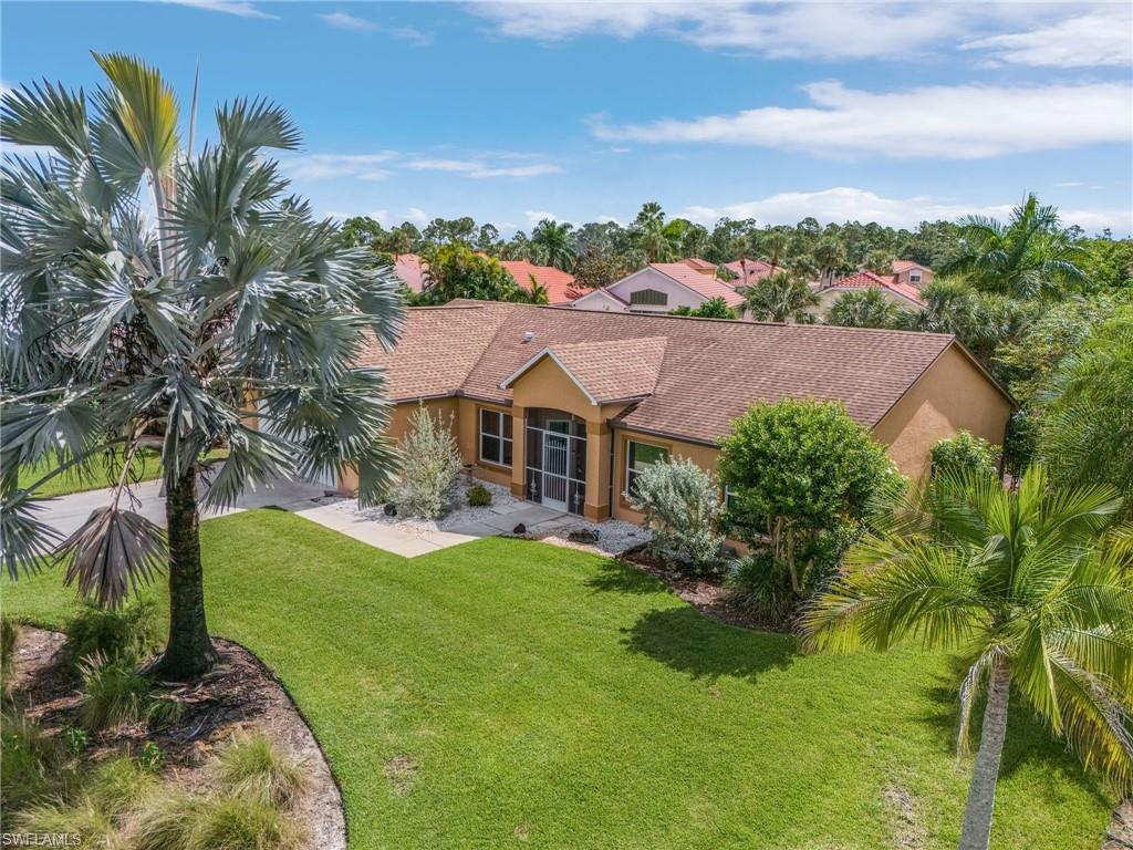 128 Plantation Circle Naples, FL 34104 - Photo 2 of 27 a view of a house with a big yard