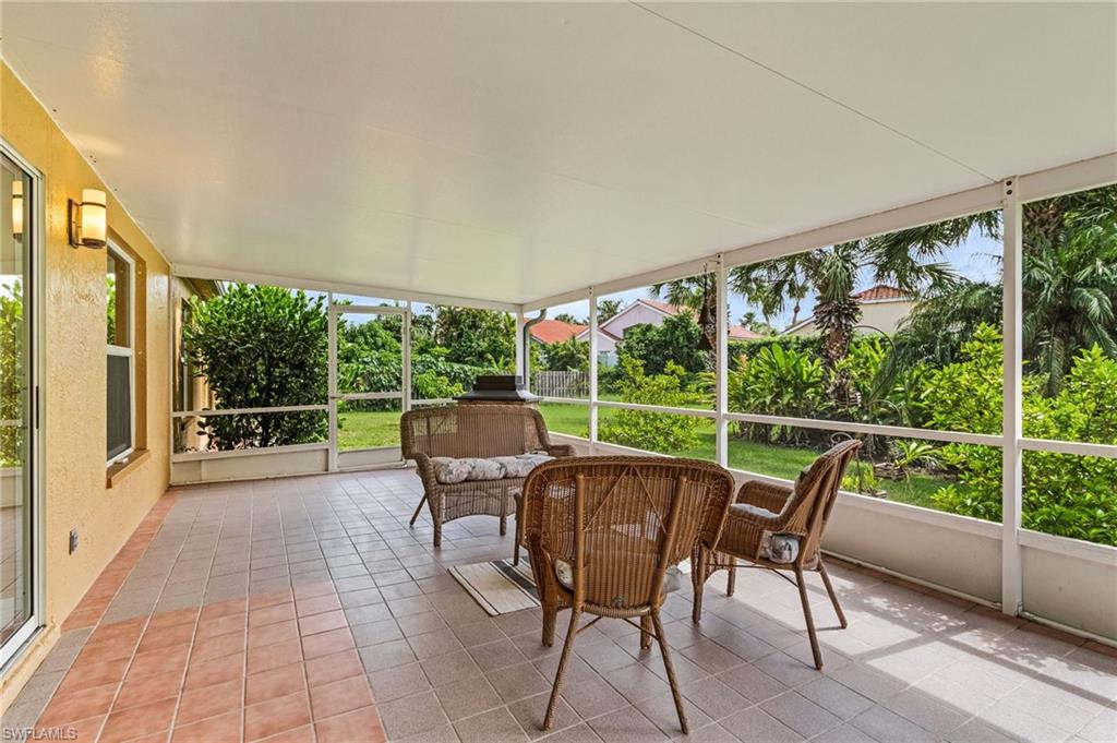 128 Plantation Circle Naples, FL 34104 - Photo 21 of 27 a view of a porch with furniture and wooden floor
