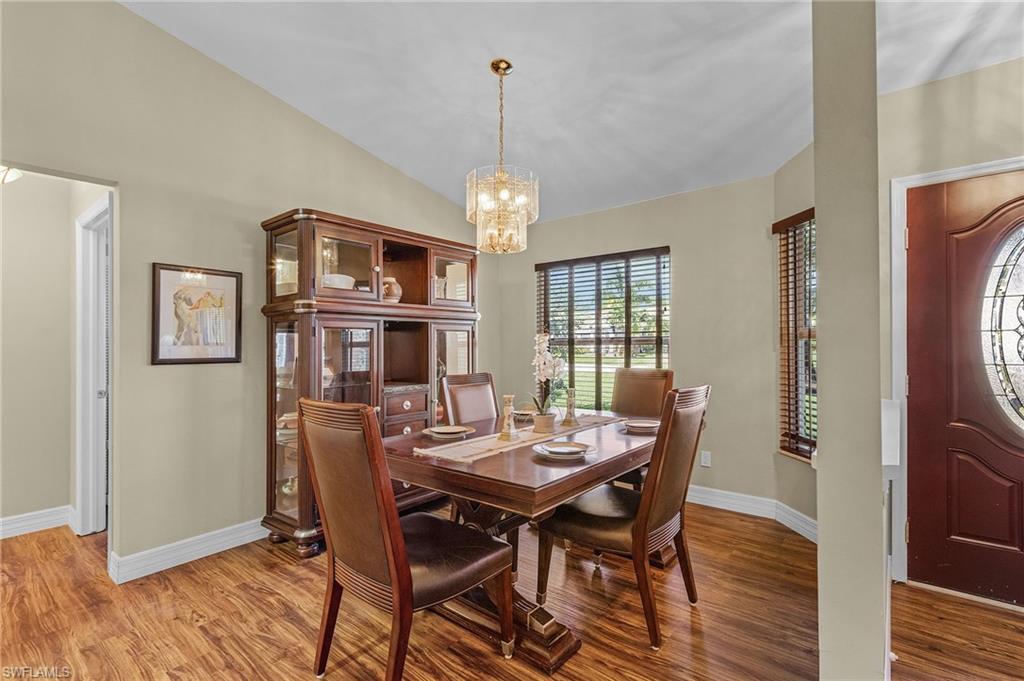 128 Plantation Circle Naples, FL 34104 - Photo 6 of 27 a view of a dining room with furniture window and wooden floor