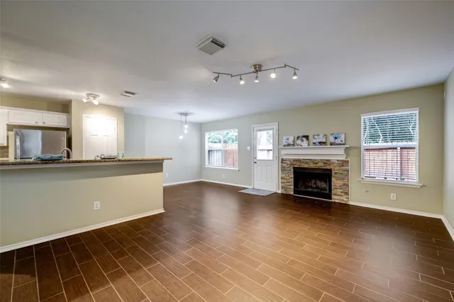 a view of an empty room with window and fire place