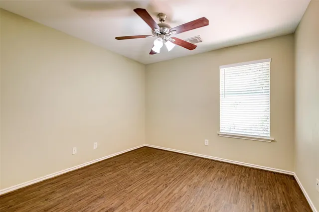 a bathroom with a granite countertop double vanity sink a mirror and a shower