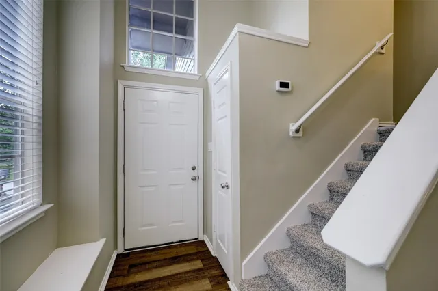 a view of a hallway with windows and stairs
