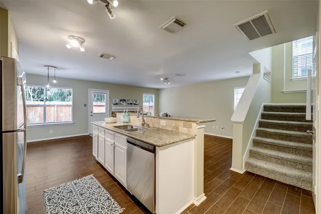a kitchen with sink and cabinets