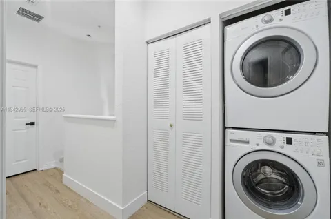 a view of a hallway with washer and dryer