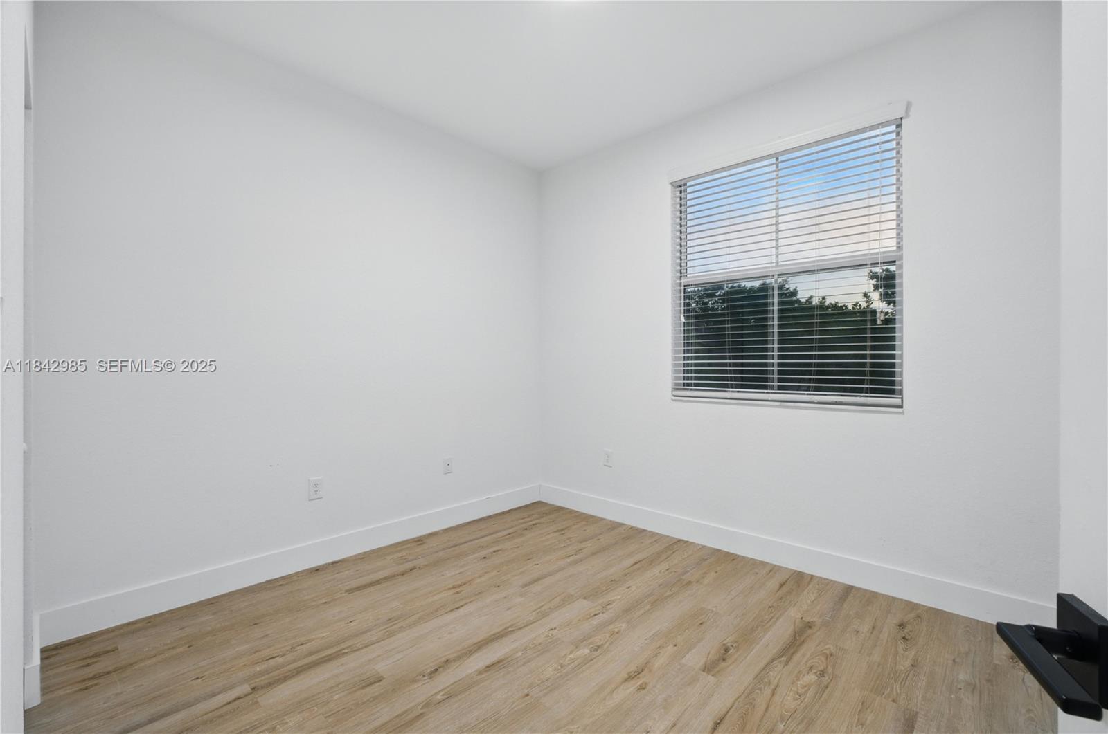 2851 Prospect Road, Unit 307 Tamarac, FL 33309 - Photo 15 of 21 a view of a room that has wooden floor and a window