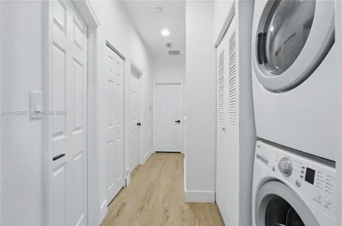 a view of a hallway with washer and dryer