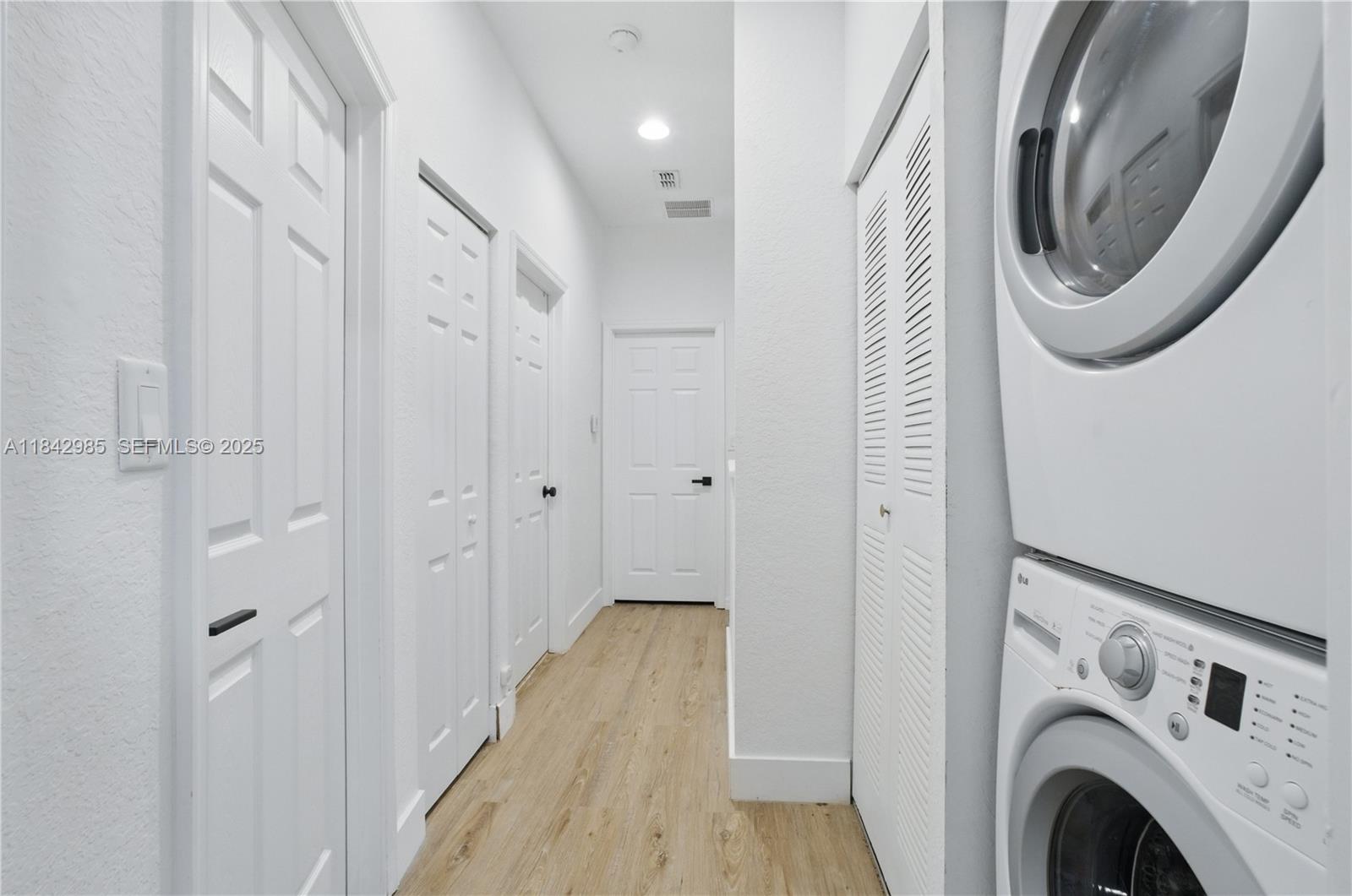 2851 Prospect Road, Unit 307 Tamarac, FL 33309 - Photo 18 of 21 a view of a hallway with washer and dryer