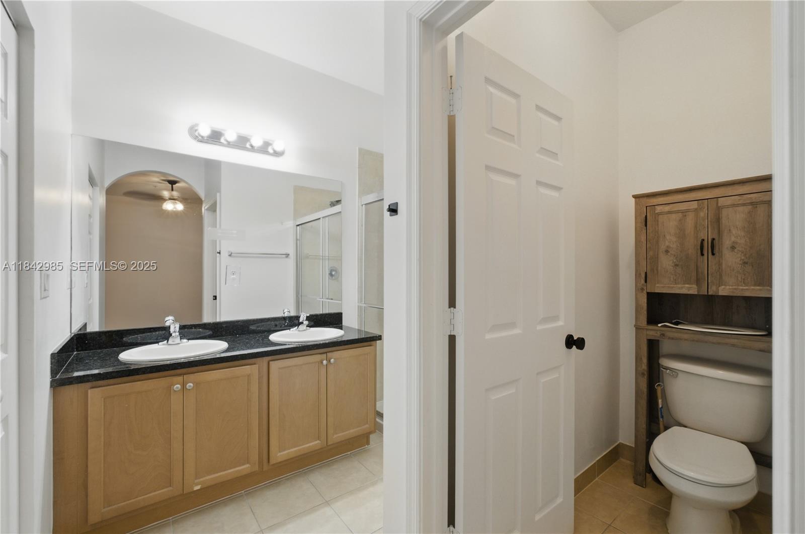 2851 Prospect Road, Unit 307 Tamarac, FL 33309 - Photo 20 of 21 a bathroom with a granite countertop sink toilet and shower