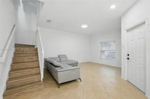 a living room with furniture and a entryway
