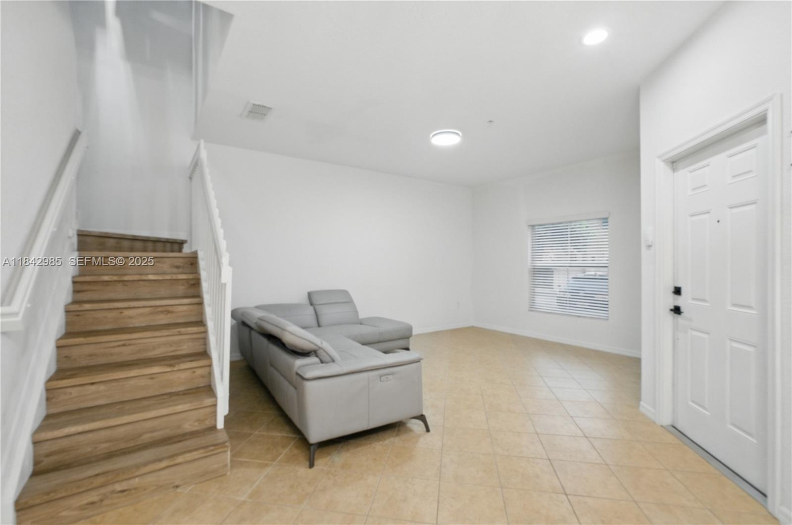 2851 Prospect Road, Unit 307 Tamarac, FL 33309 - Photo 4 of 21 a living room with furniture and a entryway