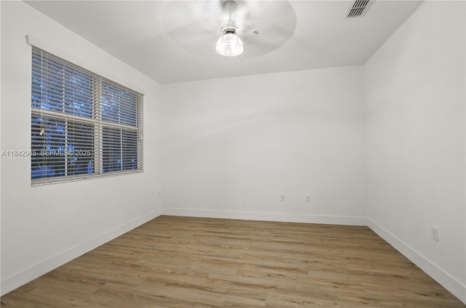 2851 Prospect Road, Unit 307 Tamarac, FL 33309 - Photo 9 of 21 a view of empty room with wooden floor and fan
