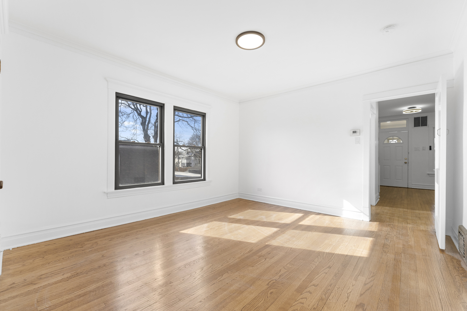 1035 South Ridgeland Avenue Oak Park, IL 60304 - Photo 19 of 33 a view of an empty room with wooden floor and a window