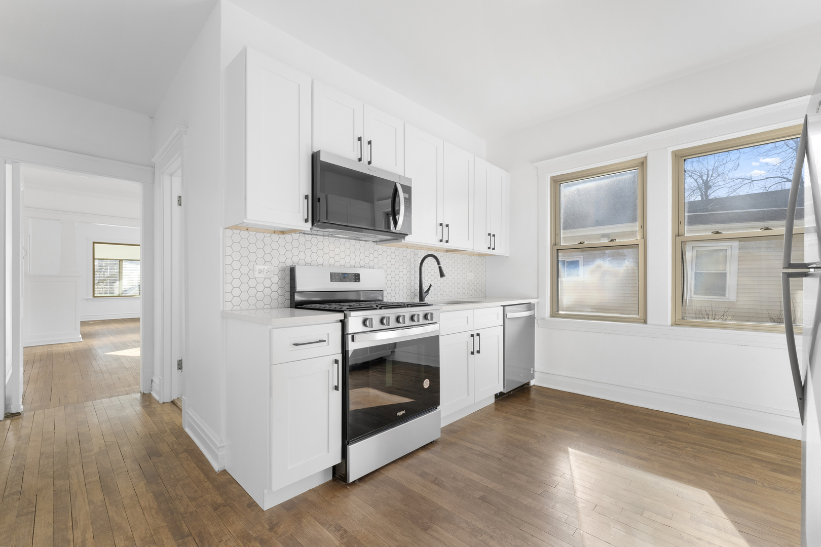 1035 South Ridgeland Avenue Oak Park, IL 60304 - Photo 9 of 33 a kitchen with stainless steel appliances white cabinets a sink and a stove
