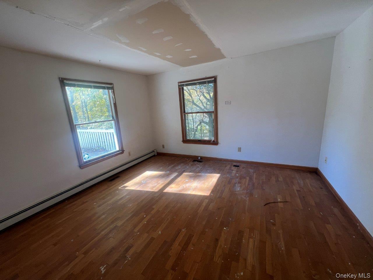 7 Felter Hill Road Monroe, NY 10950 - Photo 11 of 12 Spare room with baseboard heating, wood finished floors, and plenty of natural light